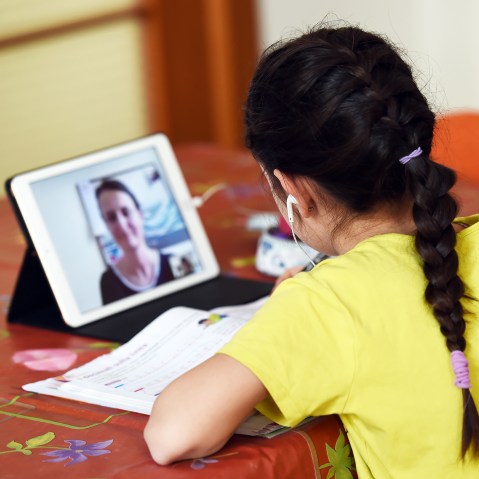 Child participates in remote learning lessons with her teacher.