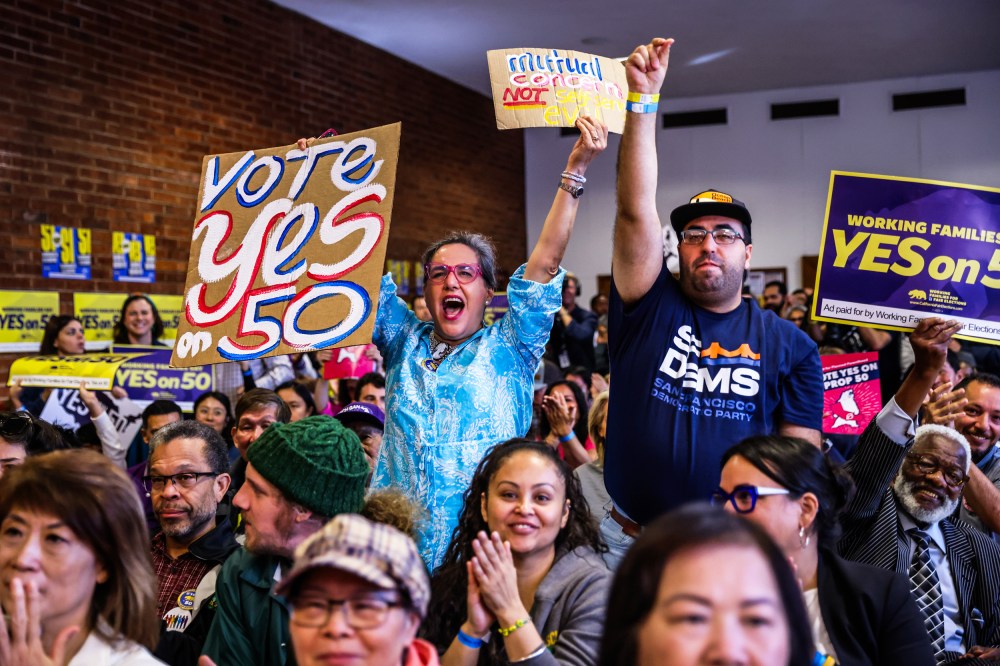 People cheer during a campaign event in support of Prop 50 in San Francisco.
