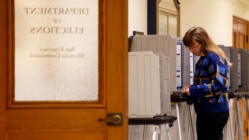 A voter fills out their ballot inside San Francisco City Hall.