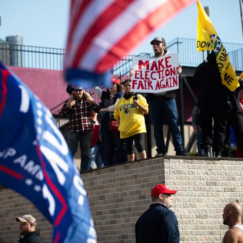Demonstrators hold signs at a pro-Trump protest during the 2020 Presidential election in Detroit.