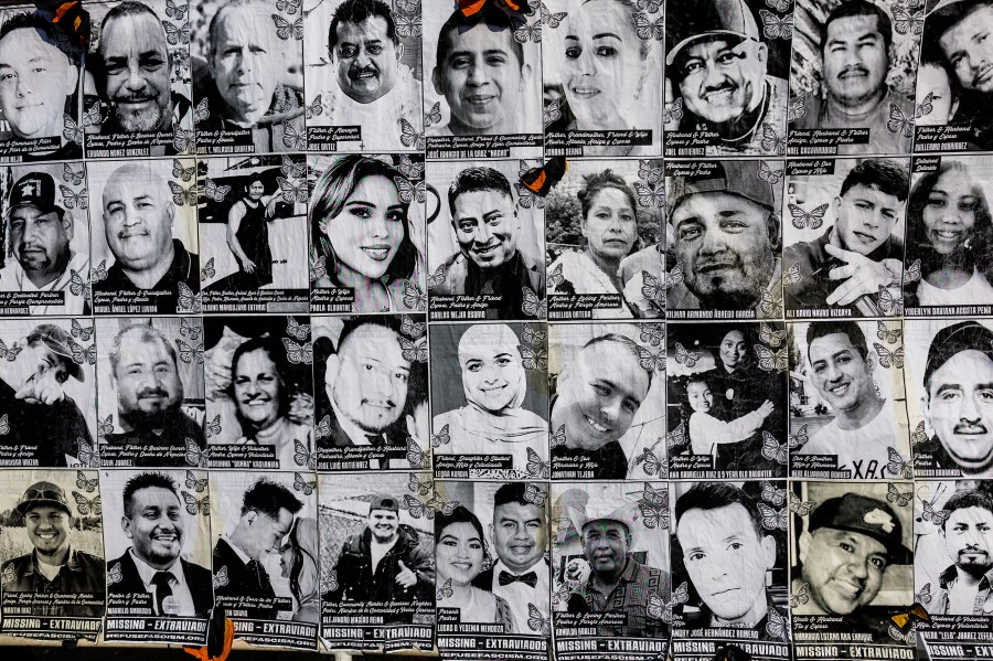 A large banner depicting faces of those who have been detained by I.C.E., seen in Los Angeles.