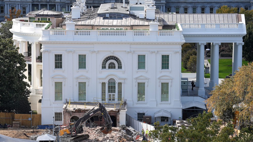An excavator works to clear rubble after the East Wing of the White House was demolished on Oct. 23, 2025.