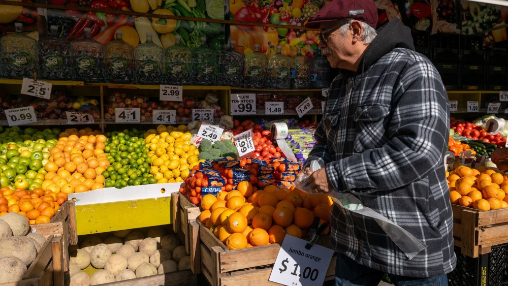 A man walks by a food market in New York City.