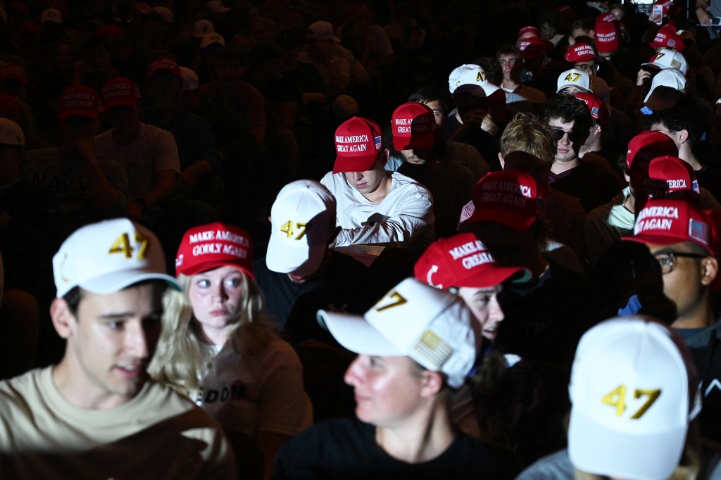 Attendees wear MAGA hats during an "American Comeback Tour" stop hosted by Turning Point USA at Virginia Tech.
