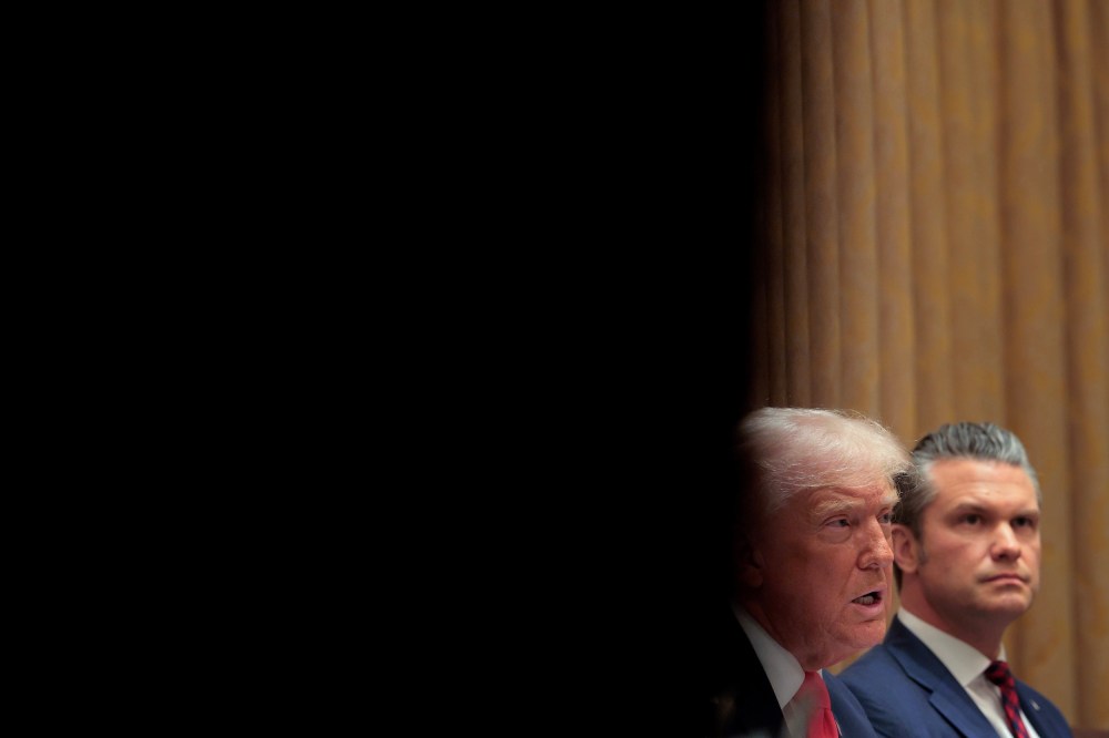 Donald Trump and Pete Hegseth sit in a Cabinet meeting