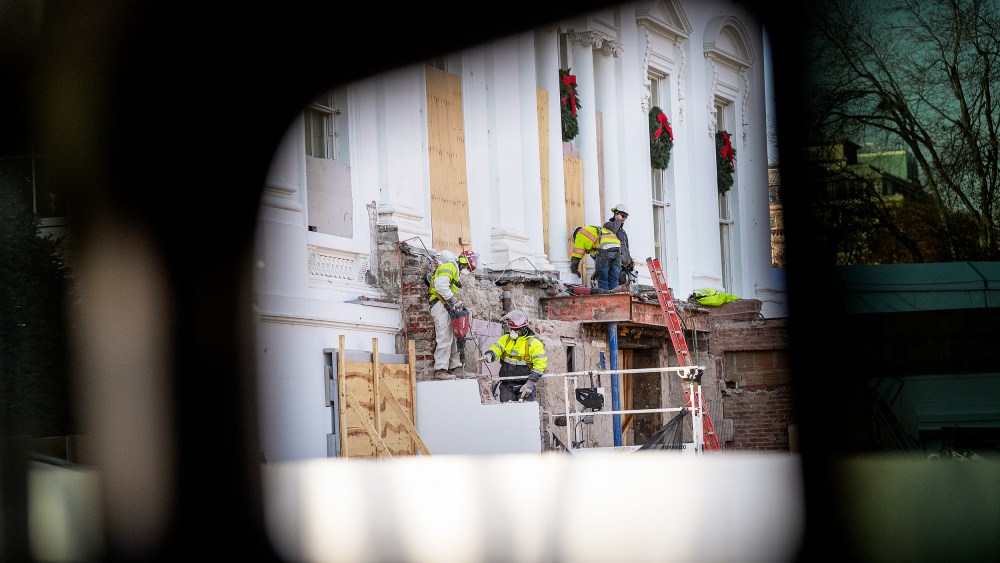 Construction workers take down material where the East Wing used to connect to the White House on Dec. 1.