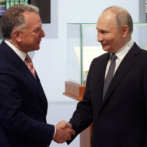 Russia’s President Vladimir Putin shakes hands with U.S. President Donald Trump’s envoy Steve Witkoff.