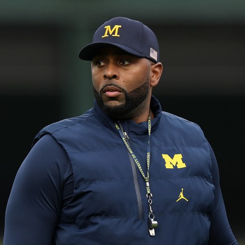Former University of Michigan Sherrone Moore of the Michigan Wolverines observes practice prior to a game.