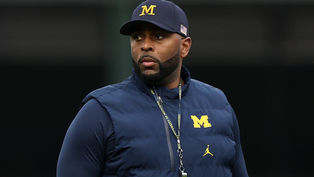 Former University of Michigan Sherrone Moore of the Michigan Wolverines observes practice prior to a game.