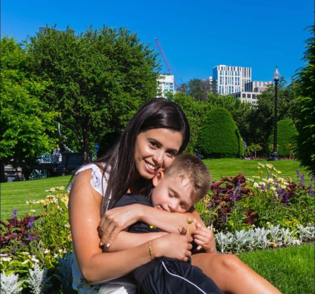 Bruna Ferreira and hugging her young son in a park