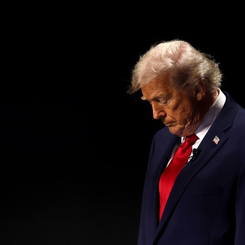 President Donald Trump on an empty-looking stage.