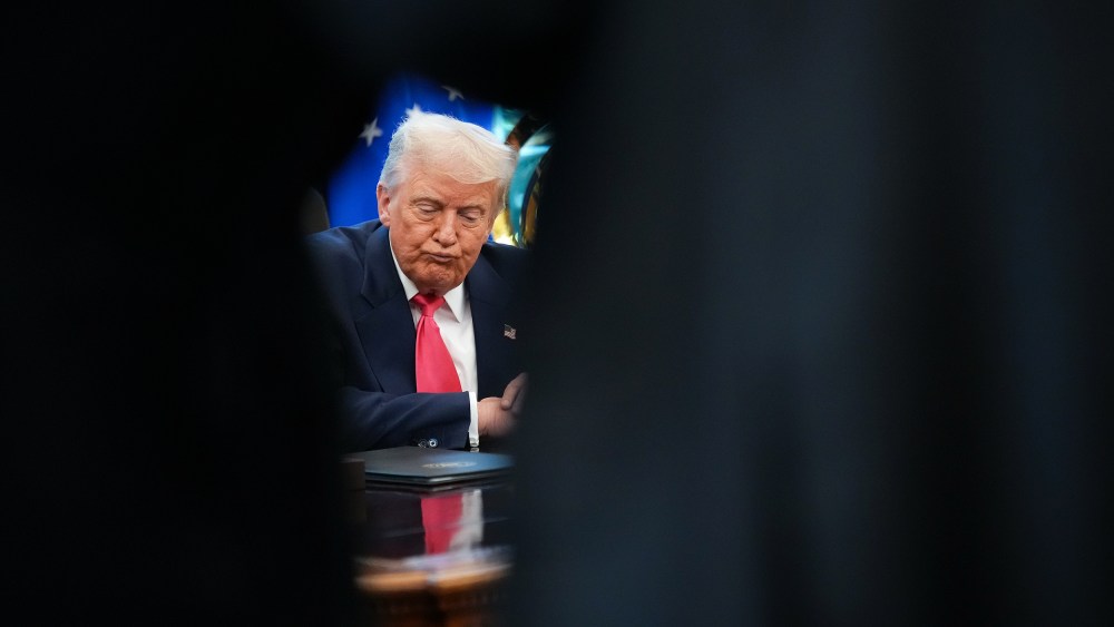 U.S. President Donald Trump answers questions from reporters in the Oval Office.