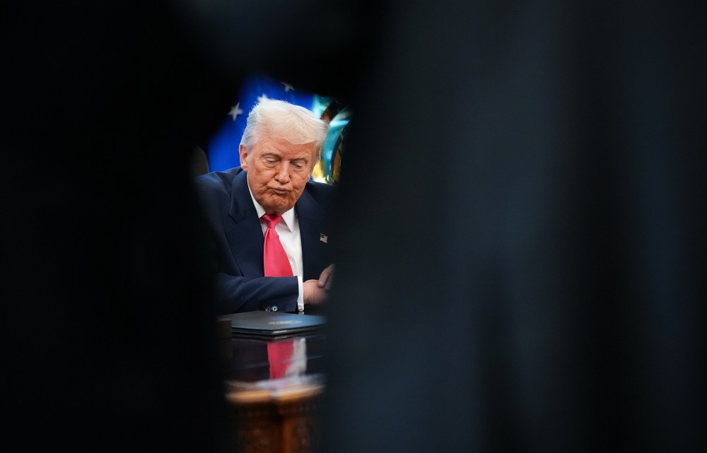 U.S. President Donald Trump answers questions from reporters in the Oval Office.