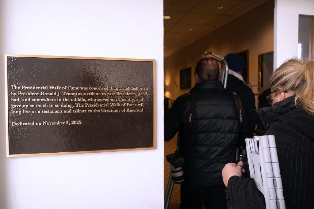 Members of the press walk past a plaque introducing "The Presidential Walk of Fame" at the White House on Dec. 17, 2025.