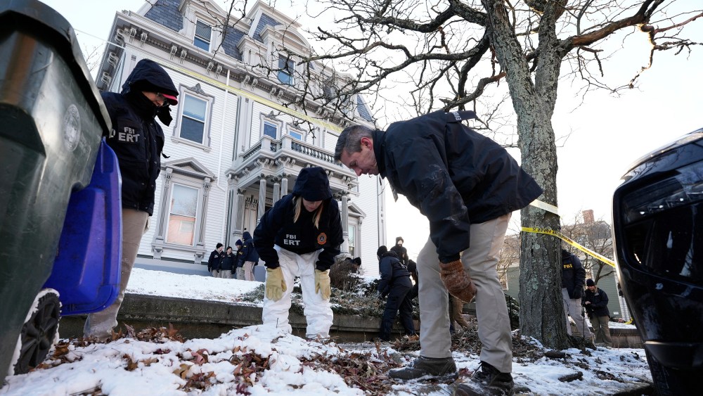 Members of the FBI Evidence Response Team search for evidence near Brown University.