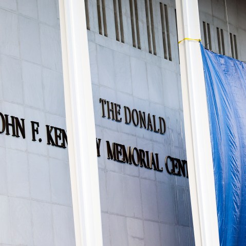 Workers adjust the name of the “John F. Kennedy Memorial Center for the Performing Arts" on Dec. 19, 2025 in Washington, D.C.