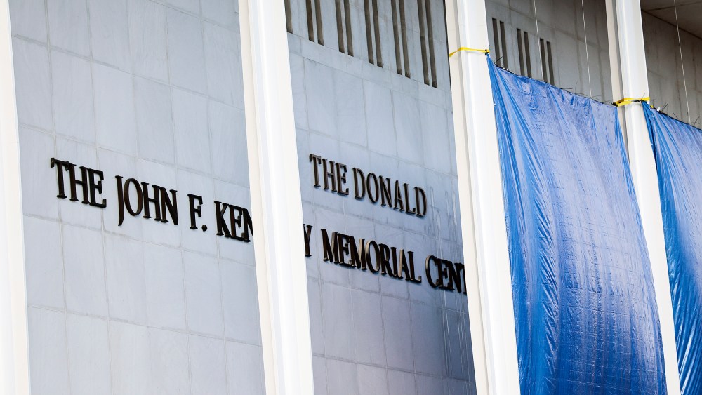 Workers adjust the name of the “John F. Kennedy Memorial Center for the Performing Arts" on Dec. 19, 2025 in Washington, D.C.
