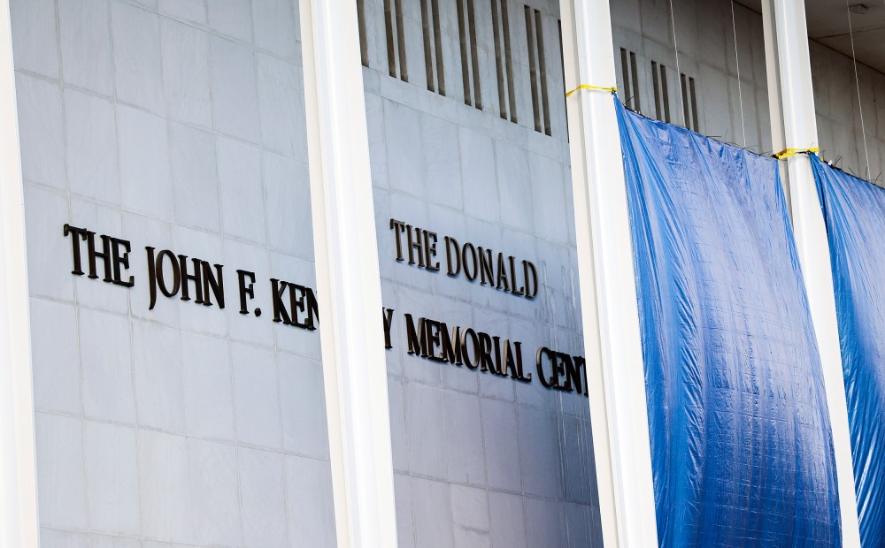 Workers adjust the name of the “John F. Kennedy Memorial Center for the Performing Arts" on Dec. 19, 2025 in Washington, D.C.