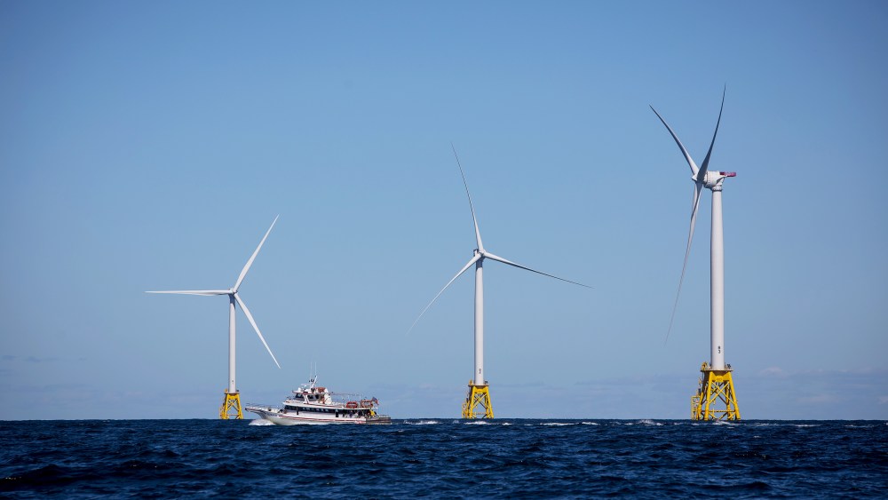 A boat passes in front of the Ørsted Block Island Wind Farm off Block Island, R.I., on Sept, 14, 2016.