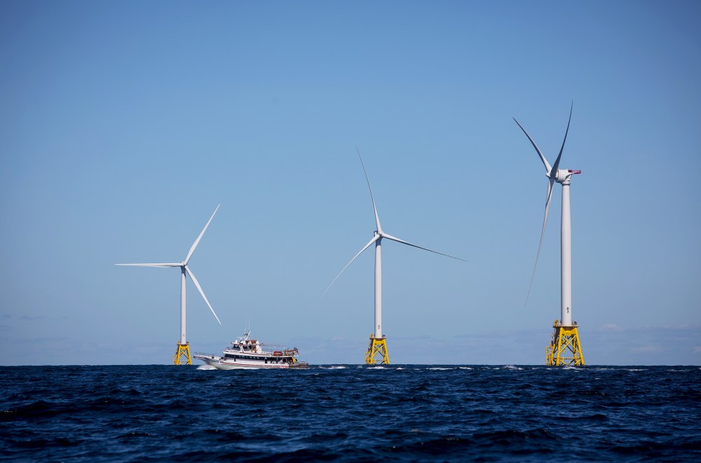A boat passes in front of the Ørsted Block Island Wind Farm off Block Island, R.I., on Sept, 14, 2016.