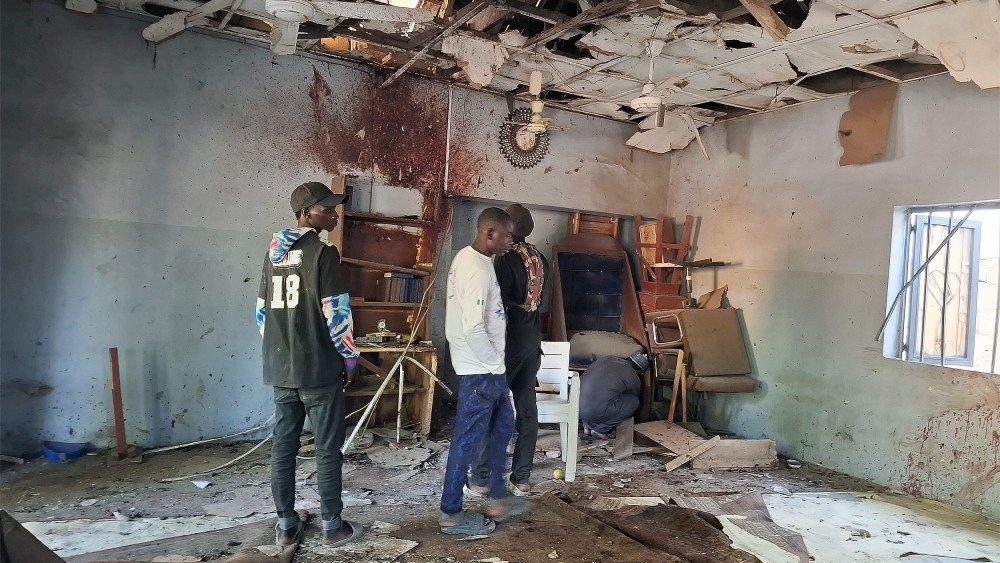 People inspect the scene of a deadly bomb explosion inside a mosque on Dec. 25 in Maiduguri, Nigeria.