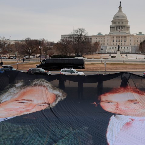 A photo of President Donald Trump and convicted sex offender Jeffrey Epstein is unfurled on the National Mall near the U.S. Capitol.