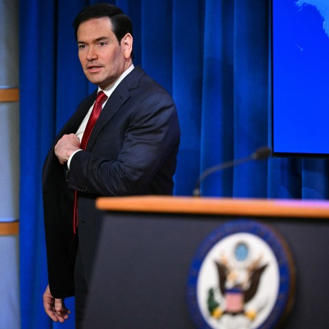 Marco Rubio arrives to speak during an end-of-year press conference.