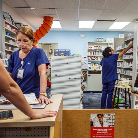 Two pharmacists at work at a CVS Pharmacy.