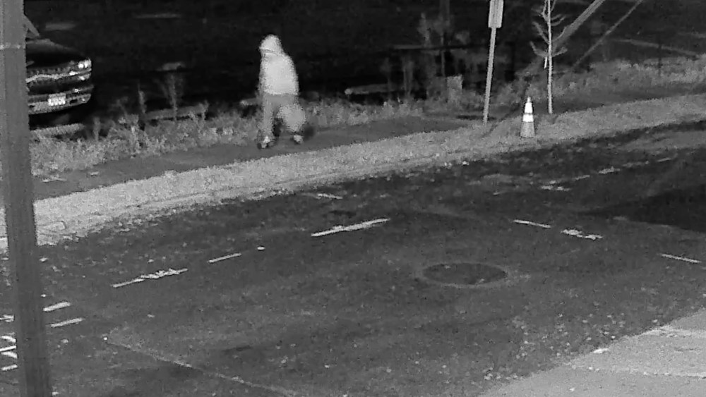 Seen in a surveillance footage, the pipe bomber case suspect is walking in the Capitol Hill neighborhood, wearing a hoodie.