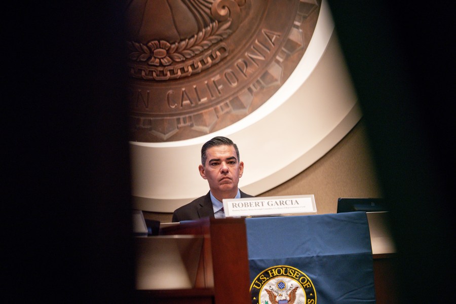 Rep. Robert Garcia sitting at a desk.