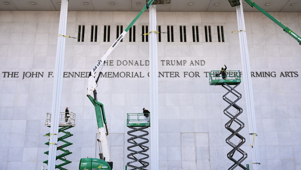 Construction people unveil new signage for the newly renamed The Donald J. Trump and The John F. Kennedy Memorial Center For The Performing Arts.
