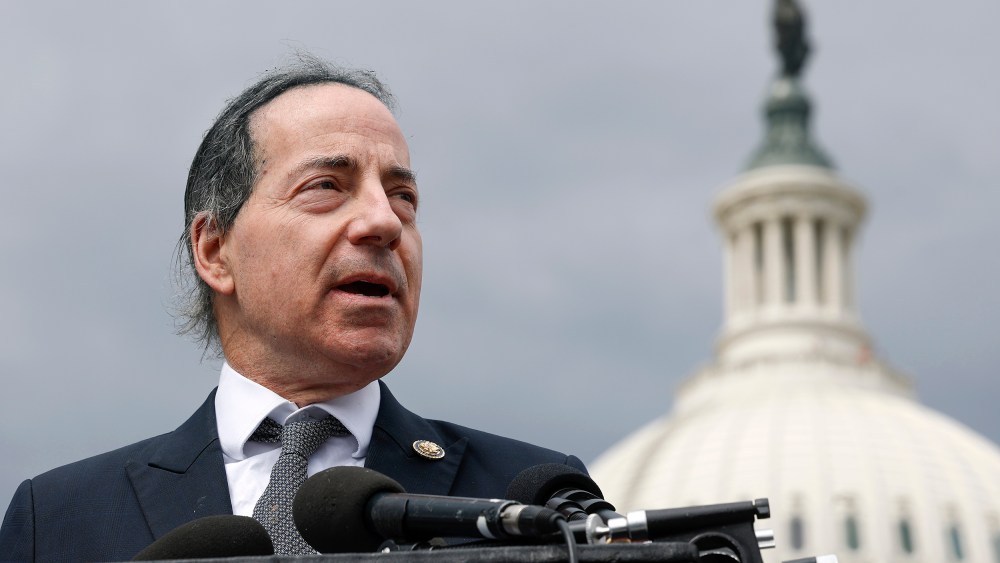 Jamie Raskin speaks at a podium in front of the US Capitol.