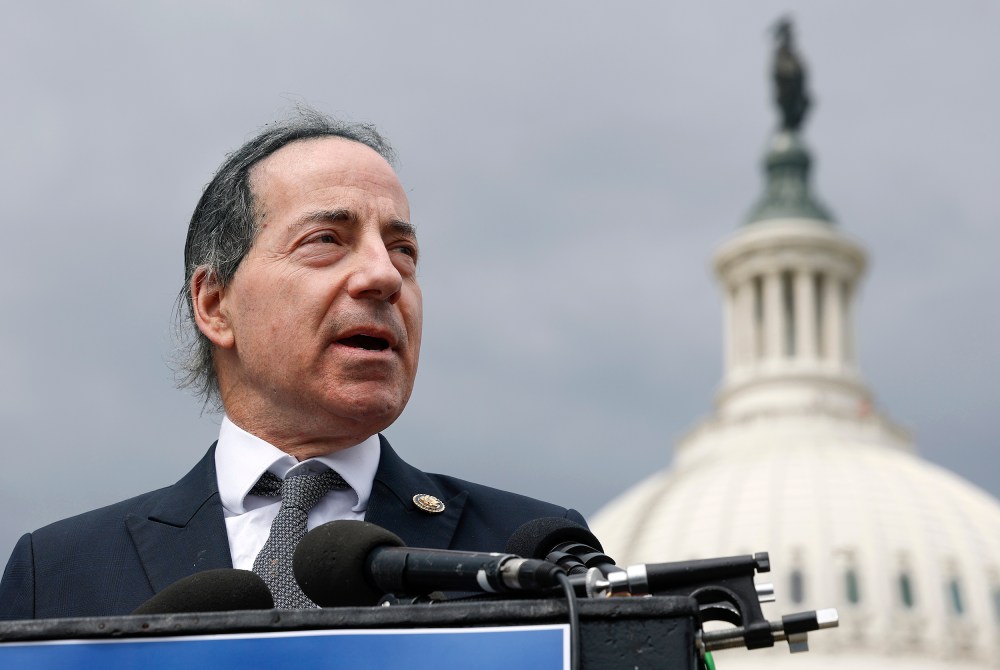 Jamie Raskin speaks at a podium in front of the US Capitol.