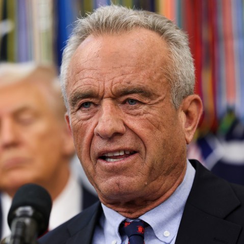 RFK Jr. speaks in the Oval Office while President Trump looks on.