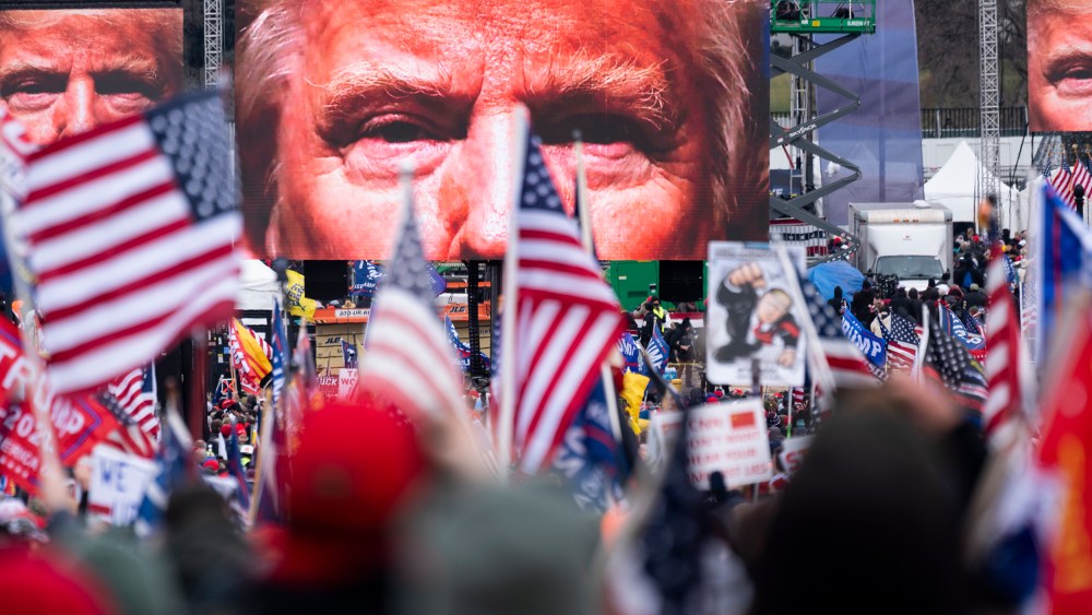 President Trump's closeup photo seen on video screens in front of a crowd at a rally.
