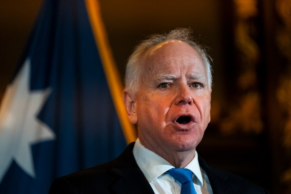 Gov. Tim Waltz speaks at the podium during a presser.