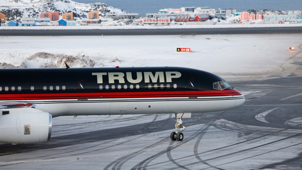 A plane with "TRUMP" written on the side sits on a snowy tarmac.