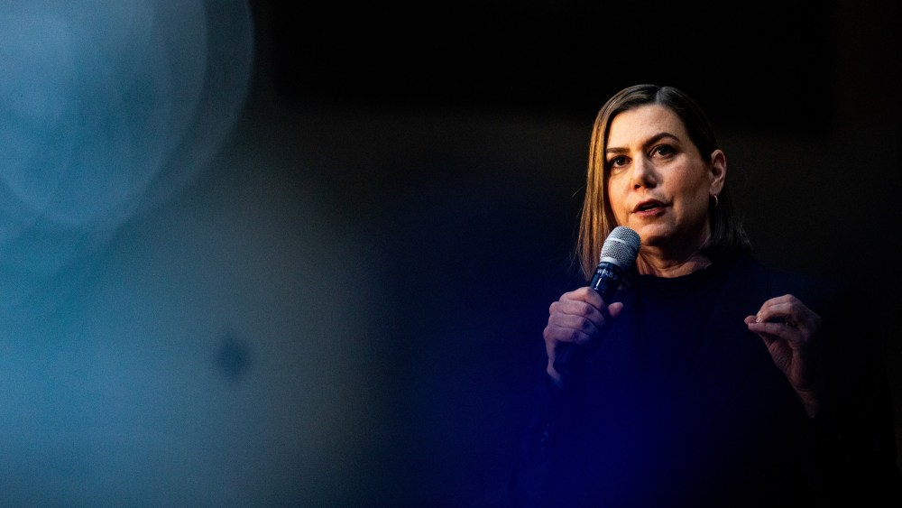 Senator Elissa Slotkin holds a microphone.
