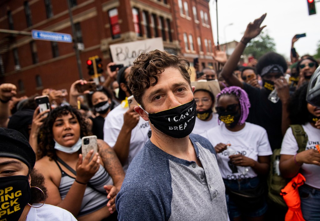 Minneapolis mayor Jacob Frey stands in front of demonstrators, wearing a mask that reads "I can't breath", one of the last few words George Floyd said before dying. This photo was taken during the early months of the pandemic.