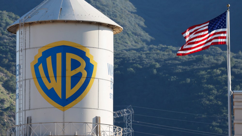 Warner Bros. logo is seen on the left, and the American flag is on the right.
