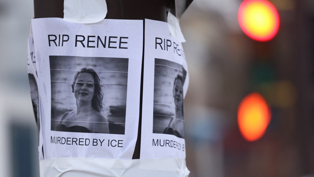 A photo of Renee Good is stapled on an electric pole.