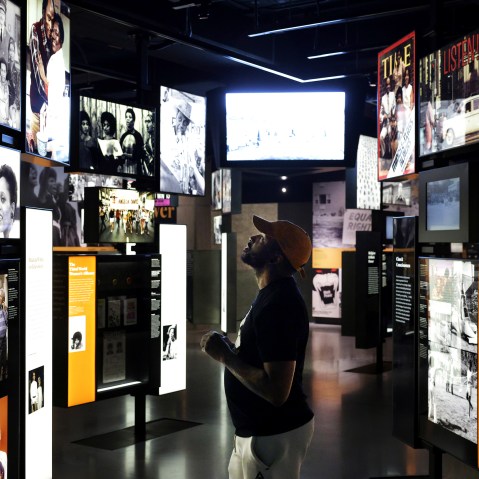 A man looks at the screens at the Smithsonian National Museum of African American History.