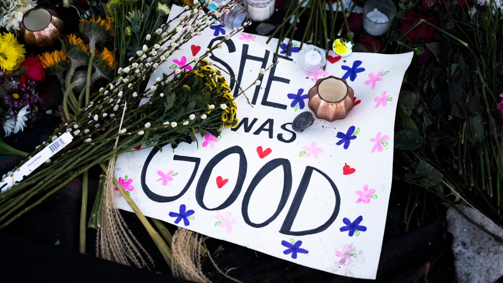 A poster reading "She Was Good" lies at a memorial near the site where Renee Good was killed a week ago, on Jan. 14, 2026 in Minneapolis, MN.