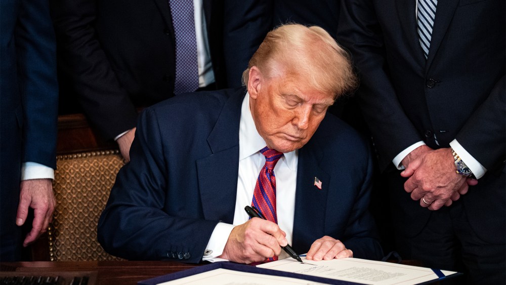 President Donald Trump signing an act on July 18, 2025, during a ceremony in the East Room of the White House.