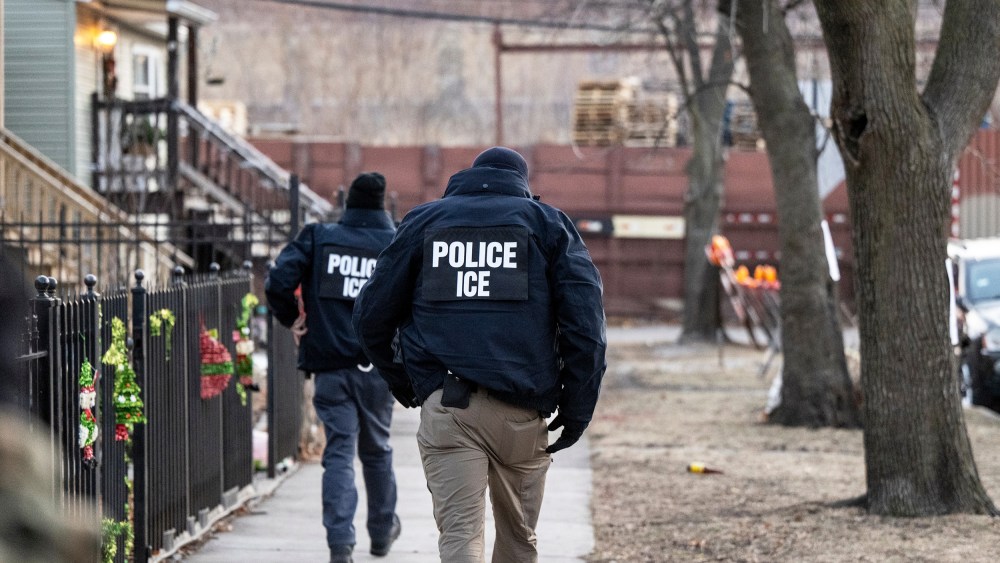U.S. Immigration and Customs Enforcement agents walk down a street on Jan. 26, 2025, in Chicago.