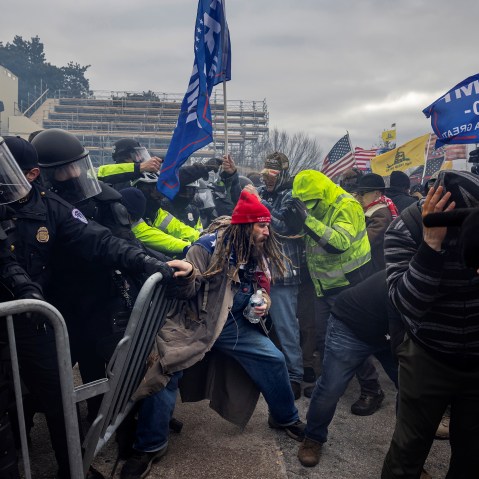 Trump supporters clash with the police - pushing each other.
