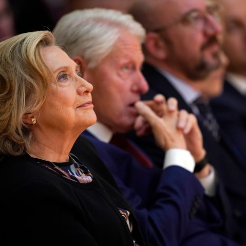 Hillary Clinton, left, and Bill Clinton sit during a conference.