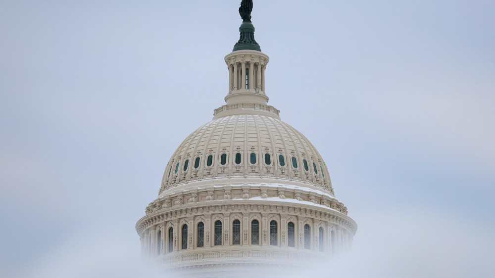Snow frames the dome of the Capitol.