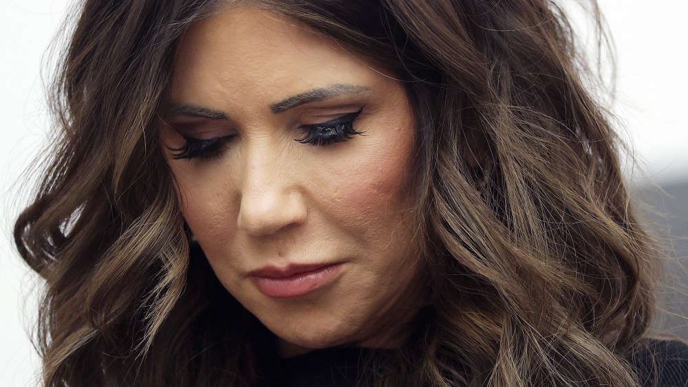 A very close-up photo shows Kristi Noem's face.