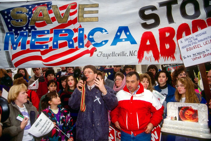 A group of pro-live activist march in the streets of DC while Randall Terry leading the group with a megaphone in hand.